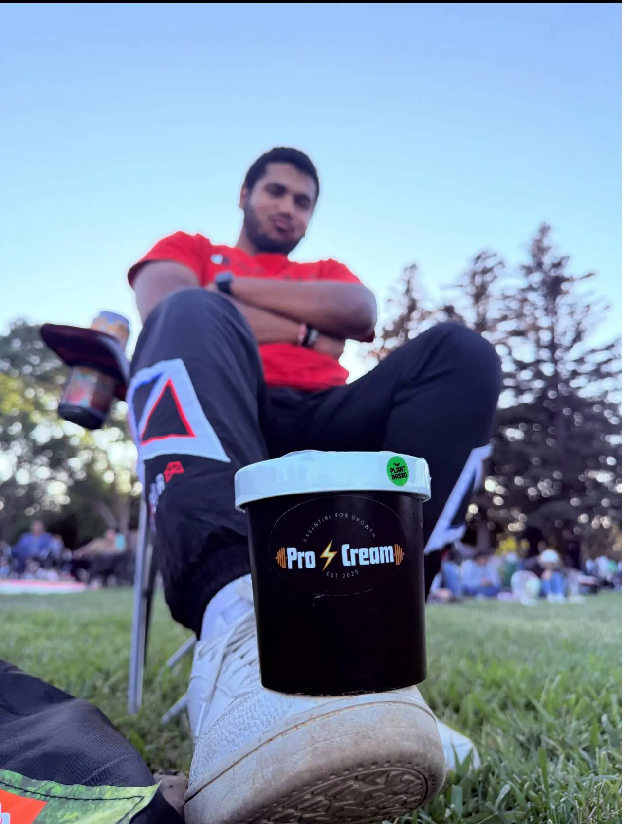 Man sitting outdoors with a coffee mug and drill.