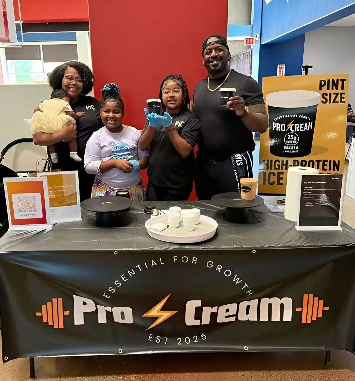 Family promoting protein ice cream at booth.