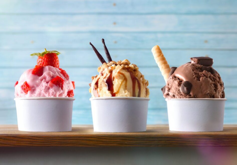 Three cups of assorted ice cream scoops.